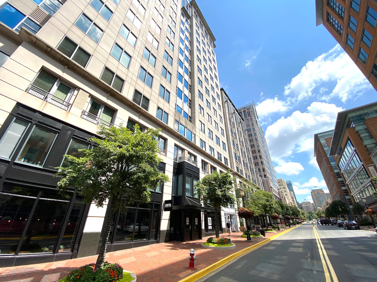about-us-02 Vibrant cityscape capturing the modern architecture of Reston, Virginia on a sunny day.