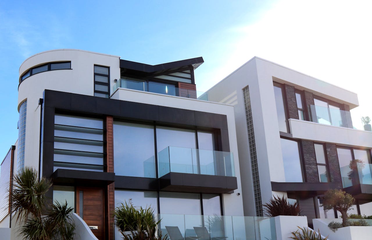 heros-img Contemporary luxury home with glass balconies in Poole, UK, showcasing modern architectural design.